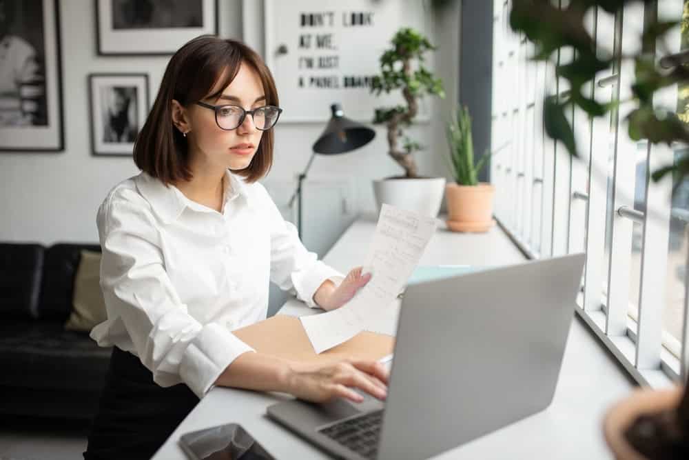 email marketing specialist reviewing documents and working on a laptop  testimonial