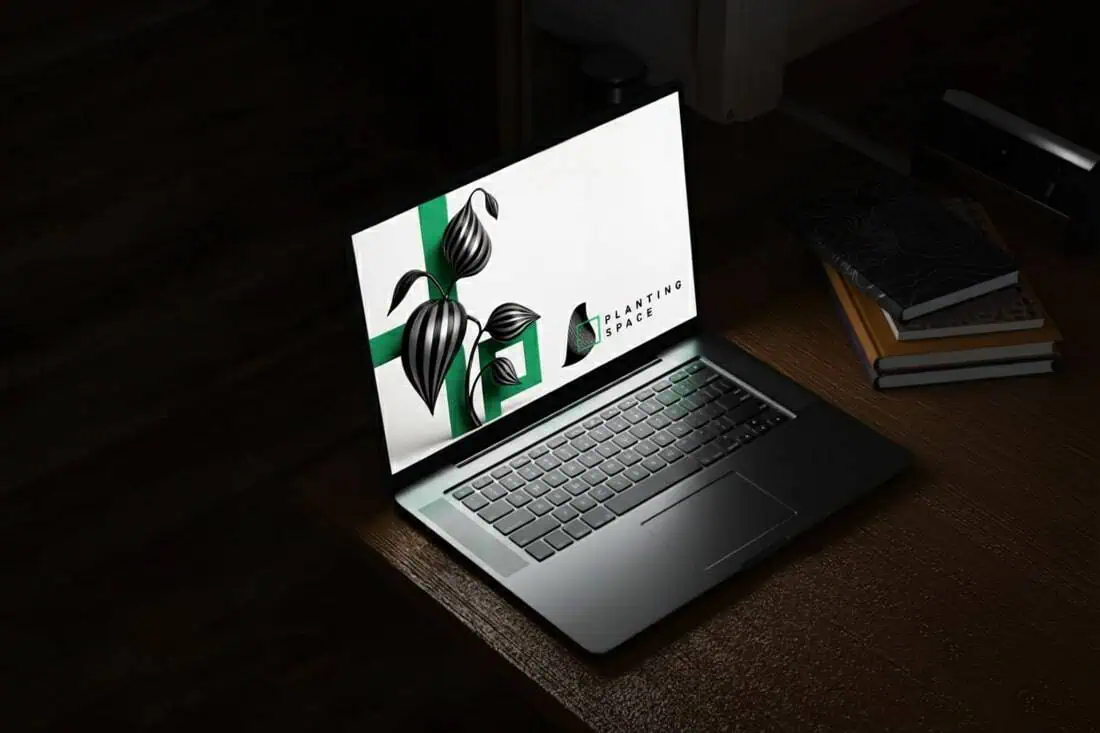 Graphic designer with tattoos working at a desk with a digital tablet and computer.