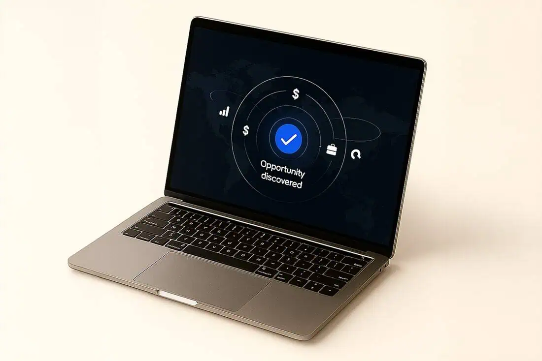 A laptop on a desk displaying an "Opportunity discovered" notification on a financial interface.
