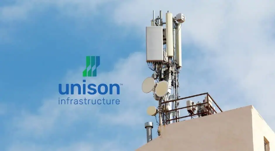 A tall telecommunications tower under a clear sky representing Unison Infrastructure.
