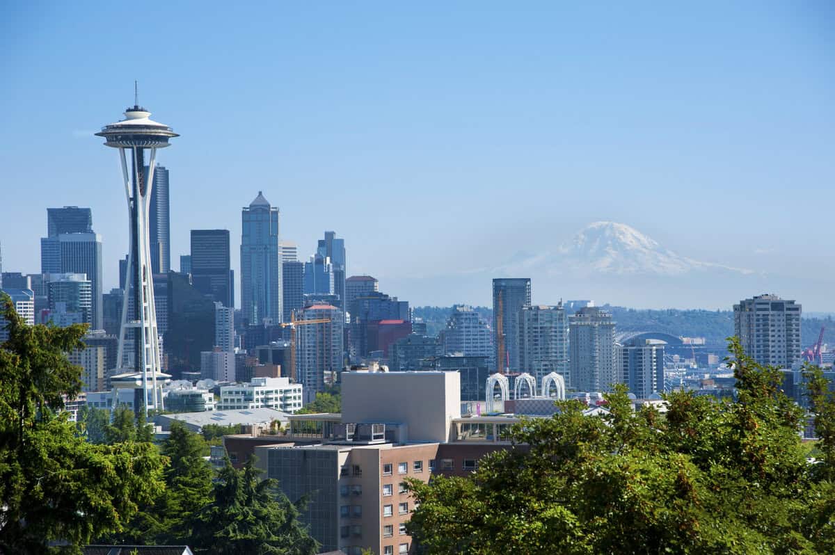 Panoramic view of downtown Seattle with the Space Needle in the foreground and Mount Rainier visible in the background. testimonial